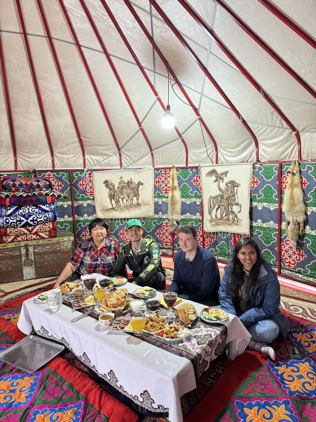 Guests sharing a meal inside a yurt