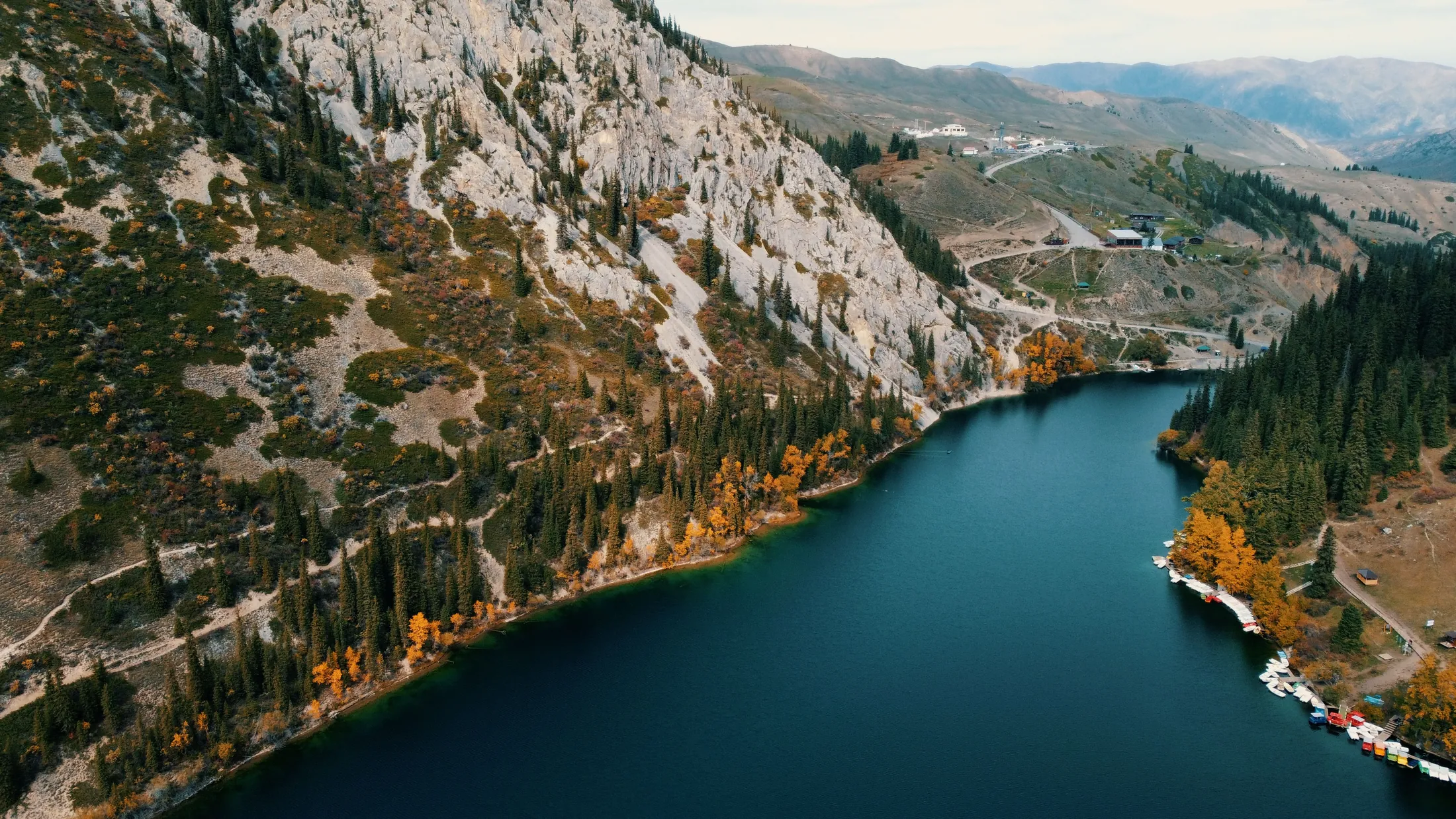 A mountain lake from above with autumn trees along its shores