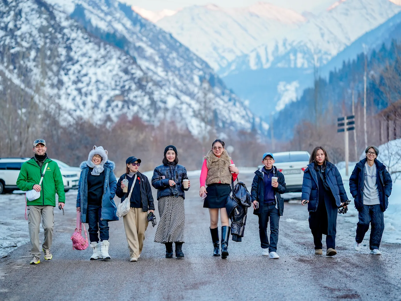 A group of travelers walking together in a snowy mountain valley