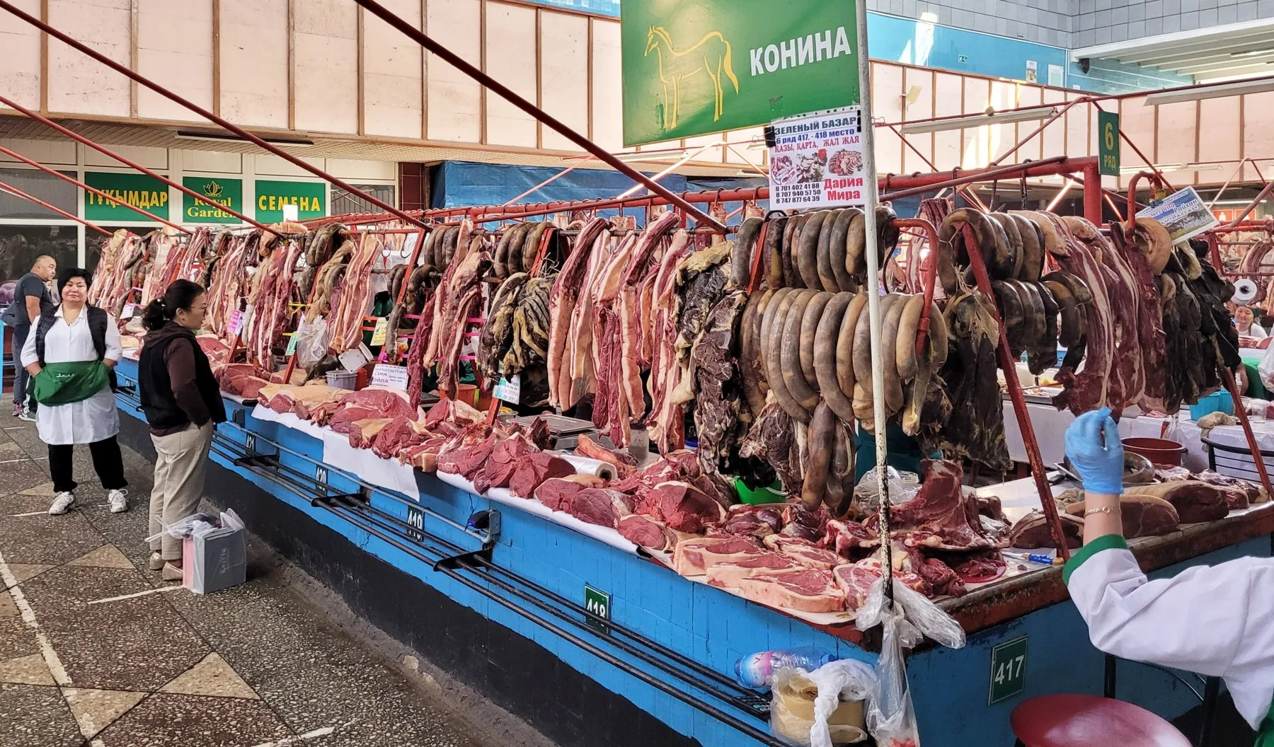 Horse meat sausages hanging over a counter at the Green Bazaar